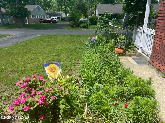 a view of a house with a yard and garden