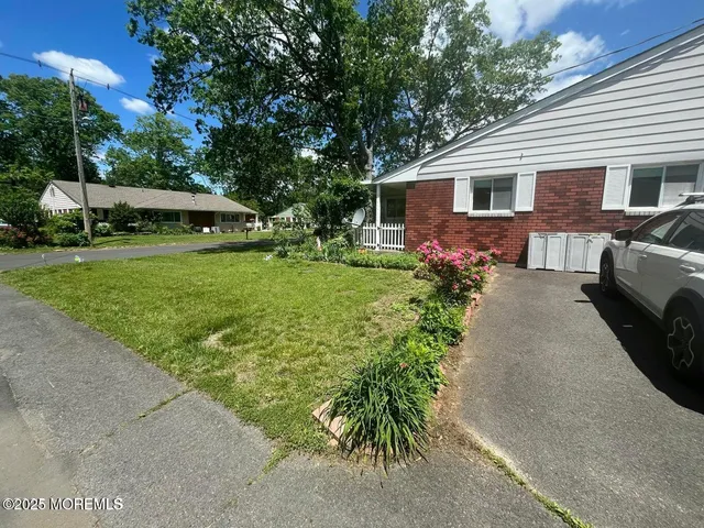 a view of a house with a yard and sitting area