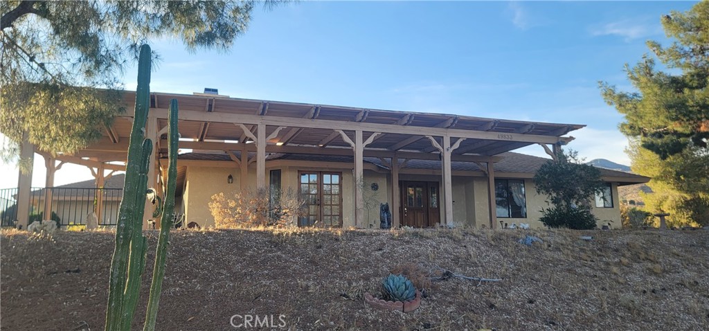 49833 Maccele Road Morongo Valley, CA 92256 - Photo 2 of 24 a view of a house with a patio