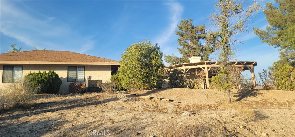 49833 Maccele Road Morongo Valley, CA 92256 - Photo 3 of 24 a view of a house with a yard
