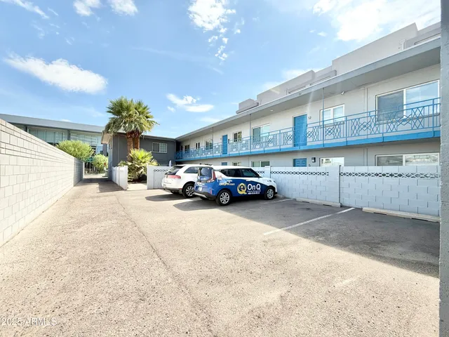 a view of a cars park in front of a building
