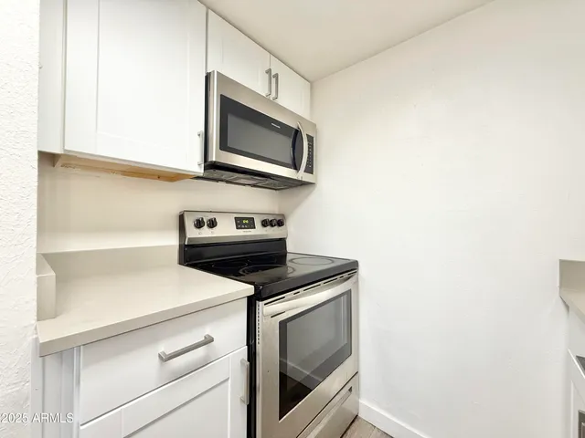 a kitchen with a stove microwave and sink