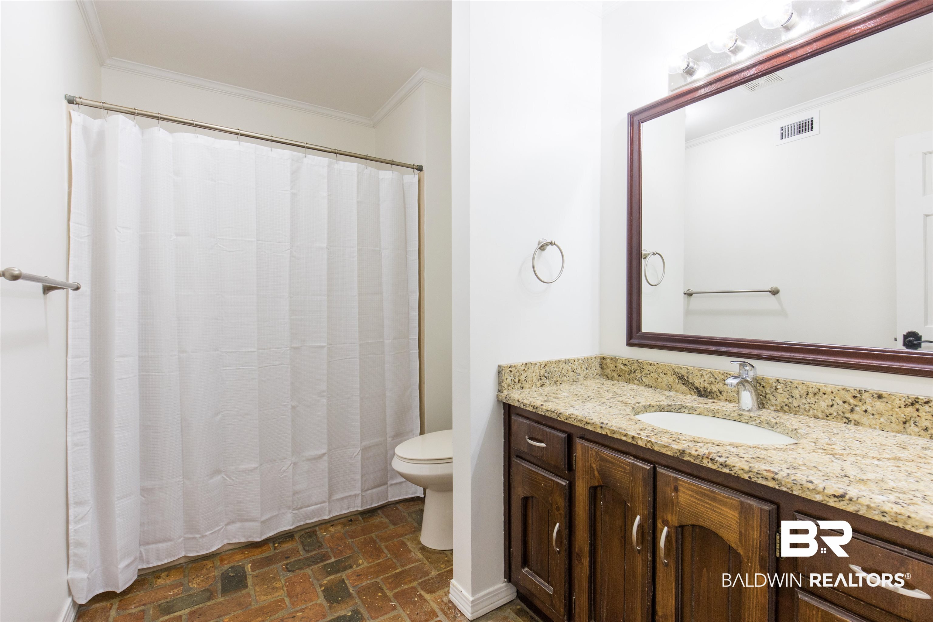 9215 Shiloh Drive Mobile, AL 36695 - Photo 16 of 32 Full bathroom featuring brick flooring, crown molding, curtained shower, and vanity
