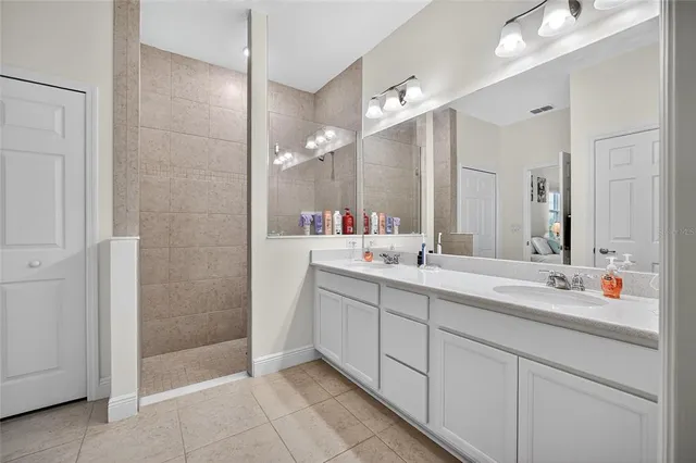 a bedroom with a bed and a ceiling fan