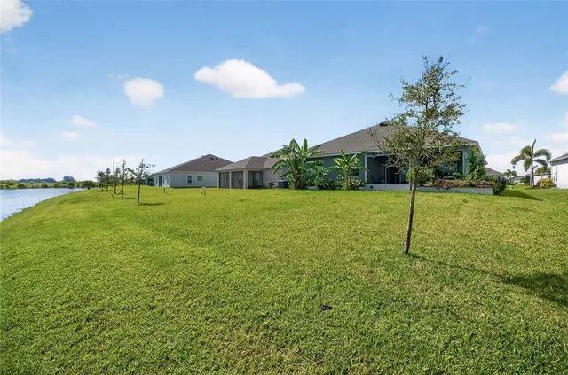 an aerial view of a house with outdoor space and lake view
