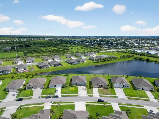 a view of a lake with houses in the back