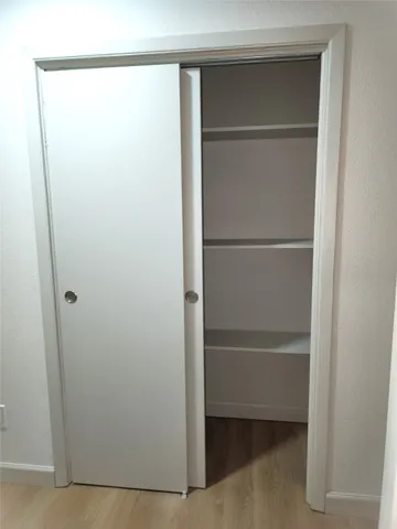 a view of walk in closet with empty racks