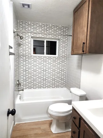 a bathroom with a toilet a sink and bathtub