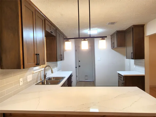 a bathroom with a sink double vanity granite tub and shower