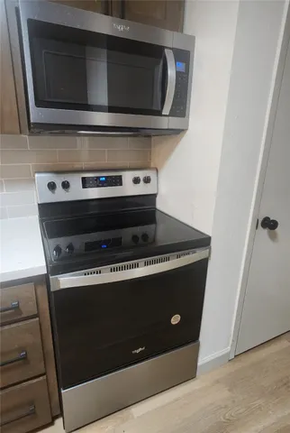 a stove top oven sitting inside of a kitchen