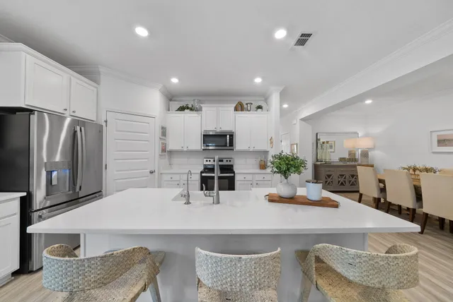 a kitchen with stainless steel appliances granite countertop a sink refrigerator and microwave