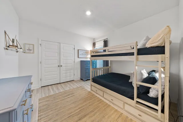 a hallway with a walk in closet and wooden floor
