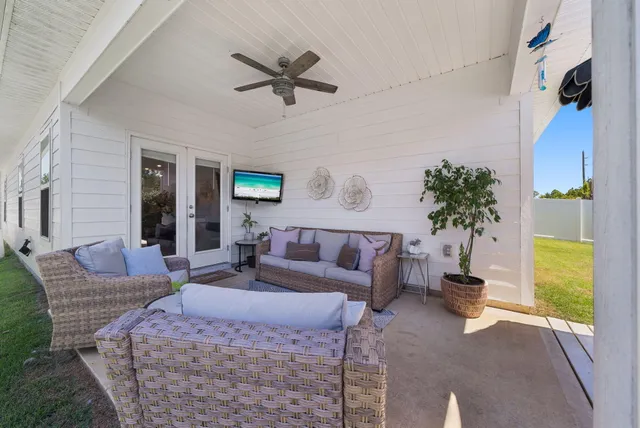 a living room with furniture and a potted plant