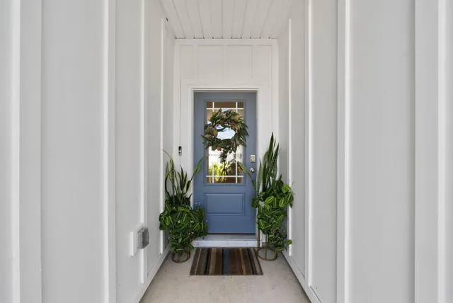 a view of a hallway with wooden floor and a entryway