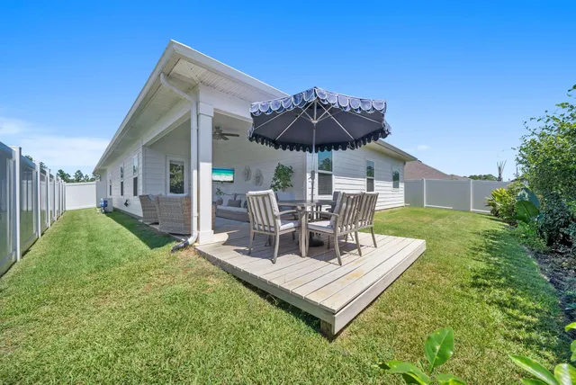 a view of a patio with a table and chairs under an umbrella