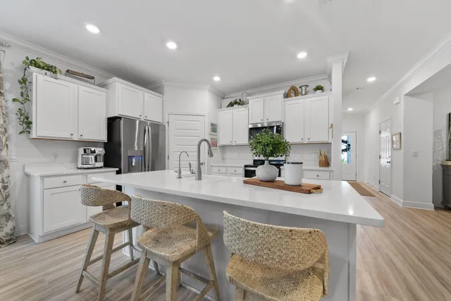 a kitchen with refrigerator and cabinets
