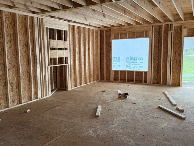 a backyard of a house with barbeque oven table and chairs