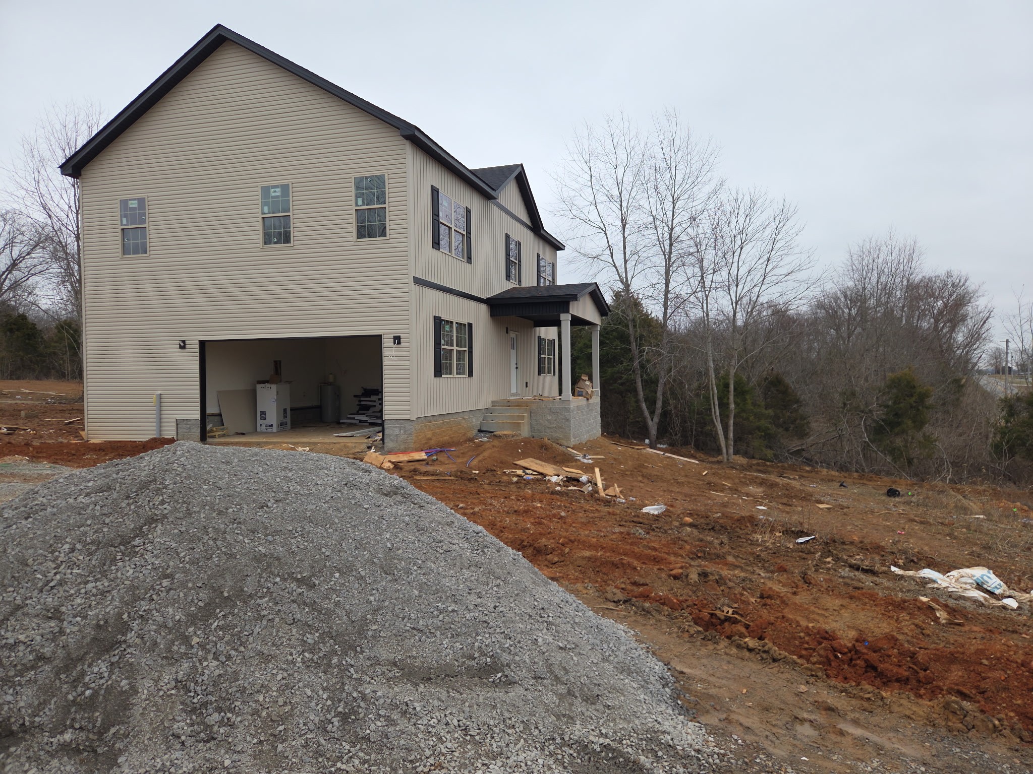 2 Caledonia Road Cadiz, KY 42211 - Photo 2 of 18 a front view of a house with a yard and garage