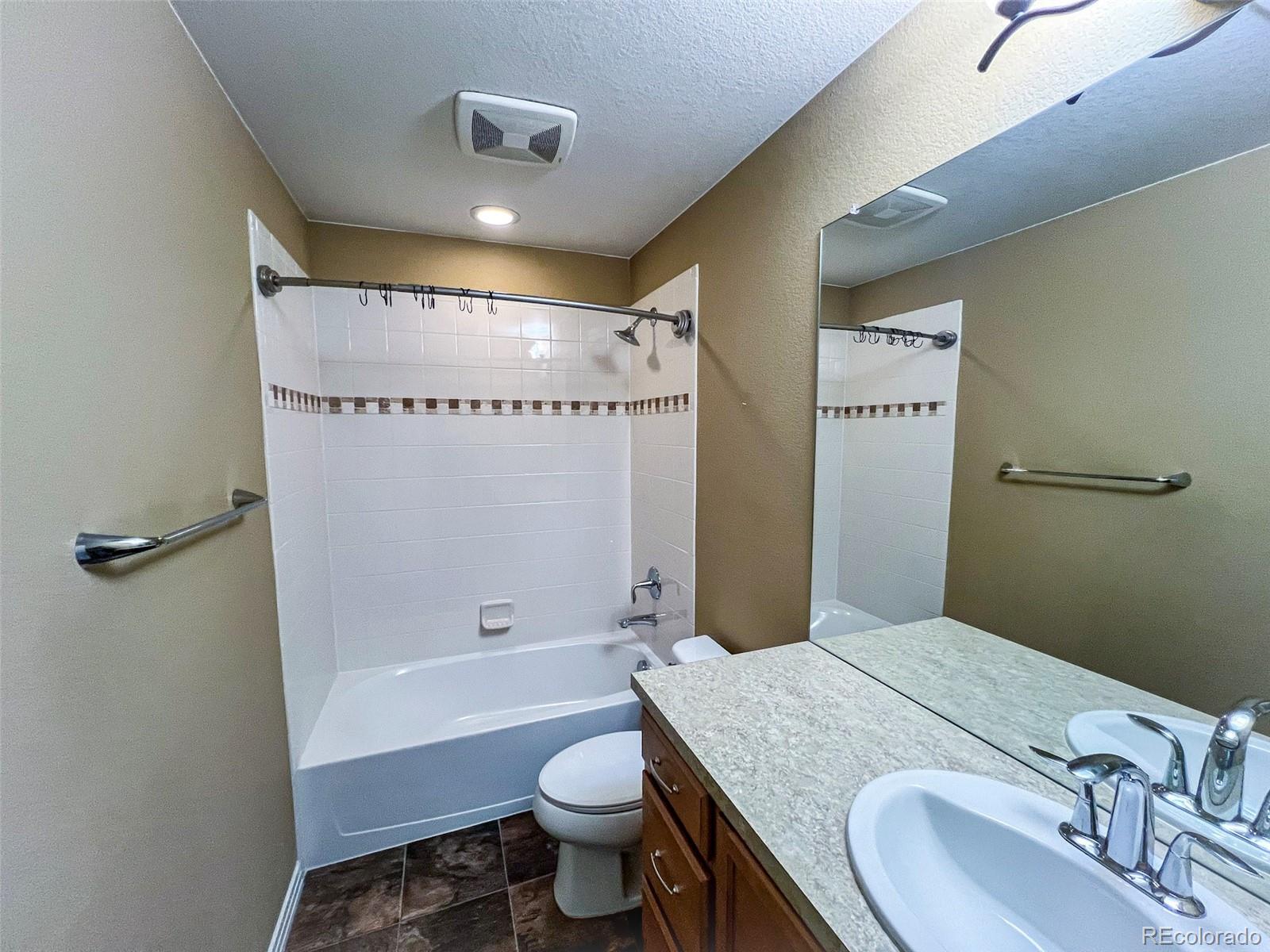 1524 Renaissance Drive Longmont, CO 80503 - Photo 14 of 23 a bathroom with a granite countertop sink toilet and shower