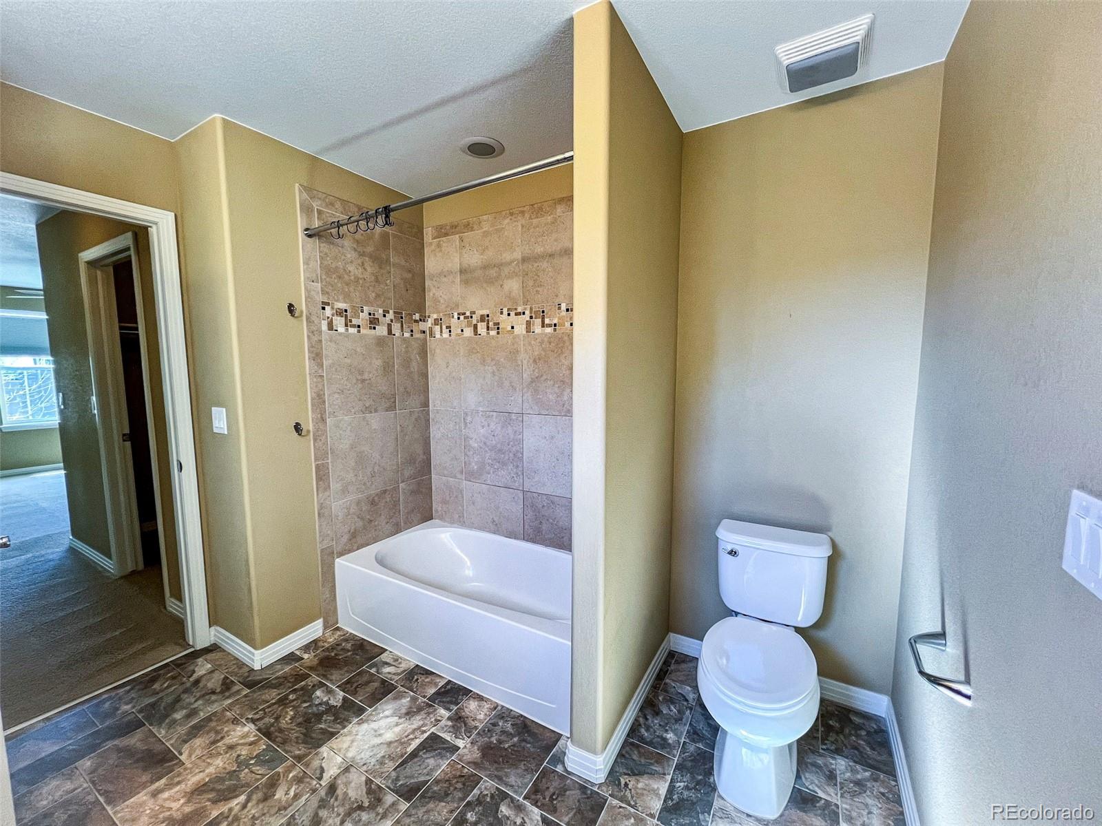 1524 Renaissance Drive Longmont, CO 80503 - Photo 17 of 23 a bathroom with a toilet and a shower