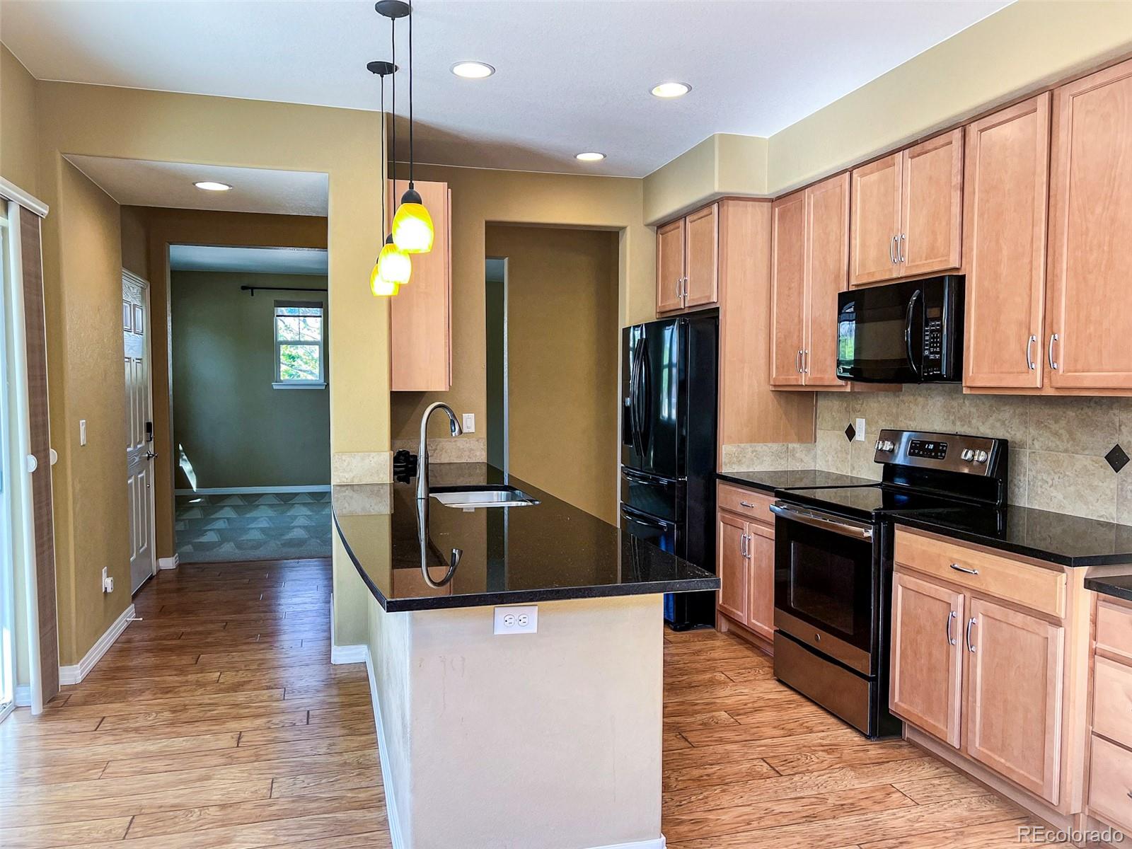 1524 Renaissance Drive Longmont, CO 80503 - Photo 8 of 23 a kitchen with stainless steel appliances granite countertop a refrigerator a stove top oven a sink and dishwasher