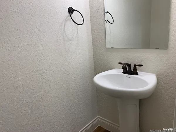 a bathroom with a sink a mirror and shower