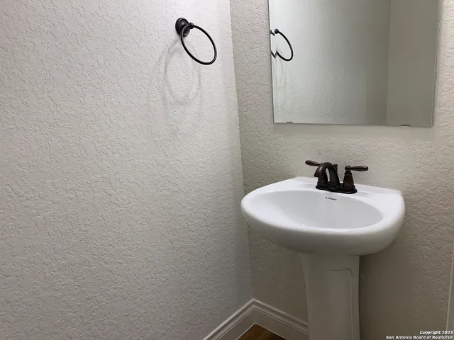 a bathroom with a sink a mirror and shower