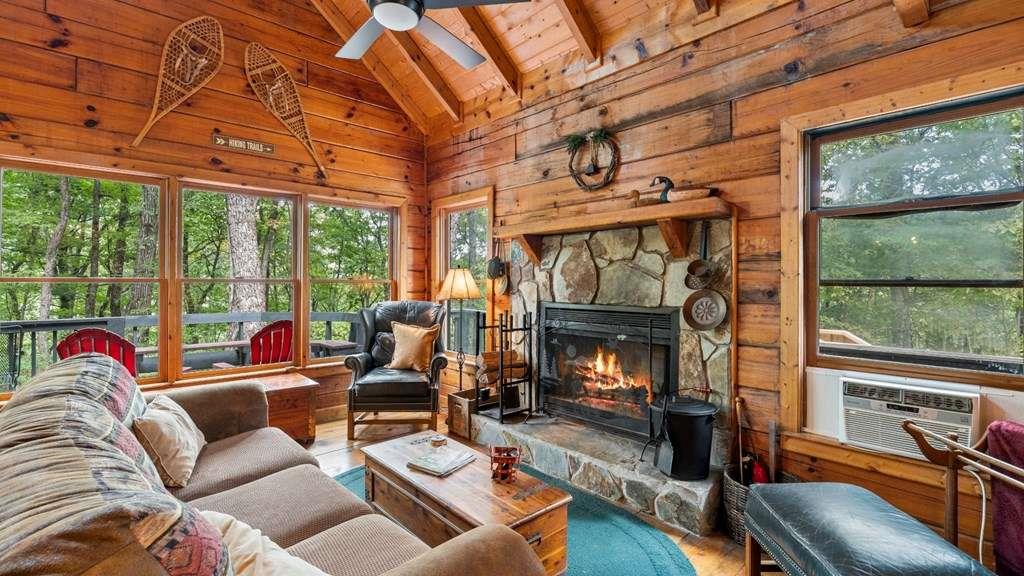 390 Butler Creek Road Cherry Log, GA 30522 - Photo 3 of 20 a living room with furniture a fireplace and floor to ceiling windows