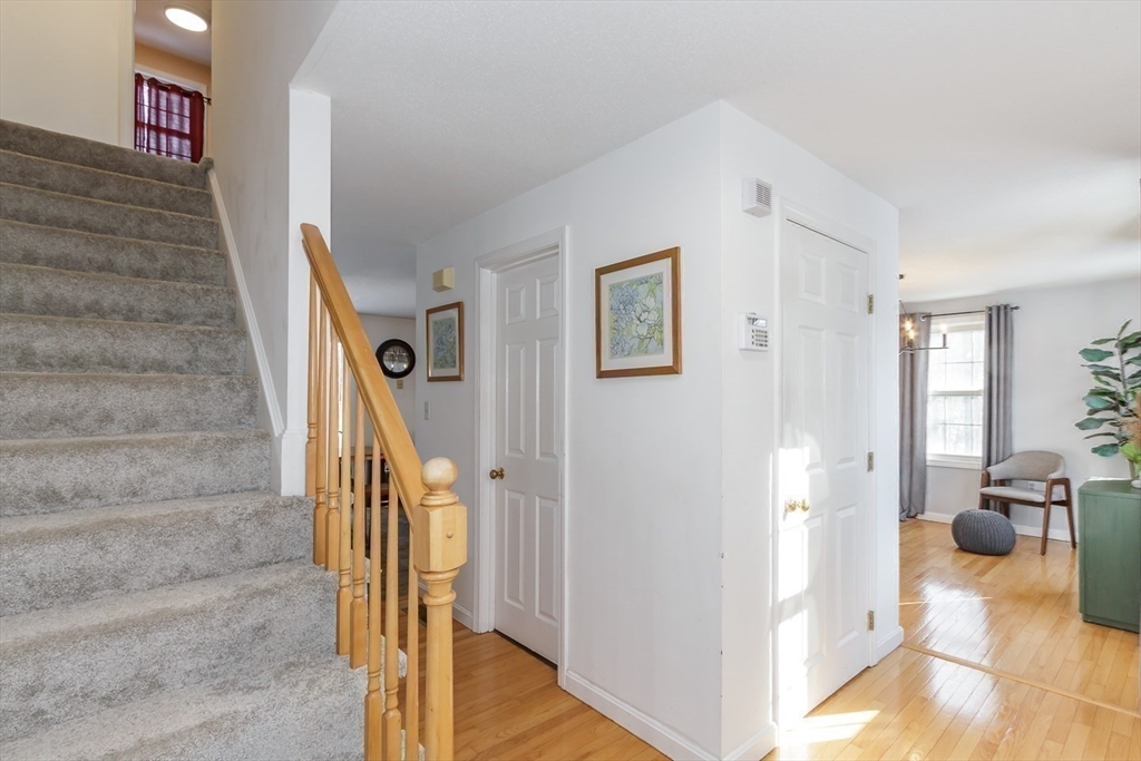 979 Hildreth Street Dracut, MA 01826 - Photo 21 of 39 a view of an entryway with wooden floor and a livingroom