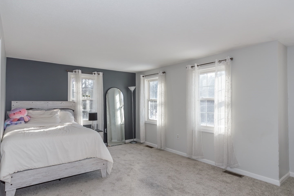 979 Hildreth Street Dracut, MA 01826 - Photo 22 of 39 a room with a bed and a large window