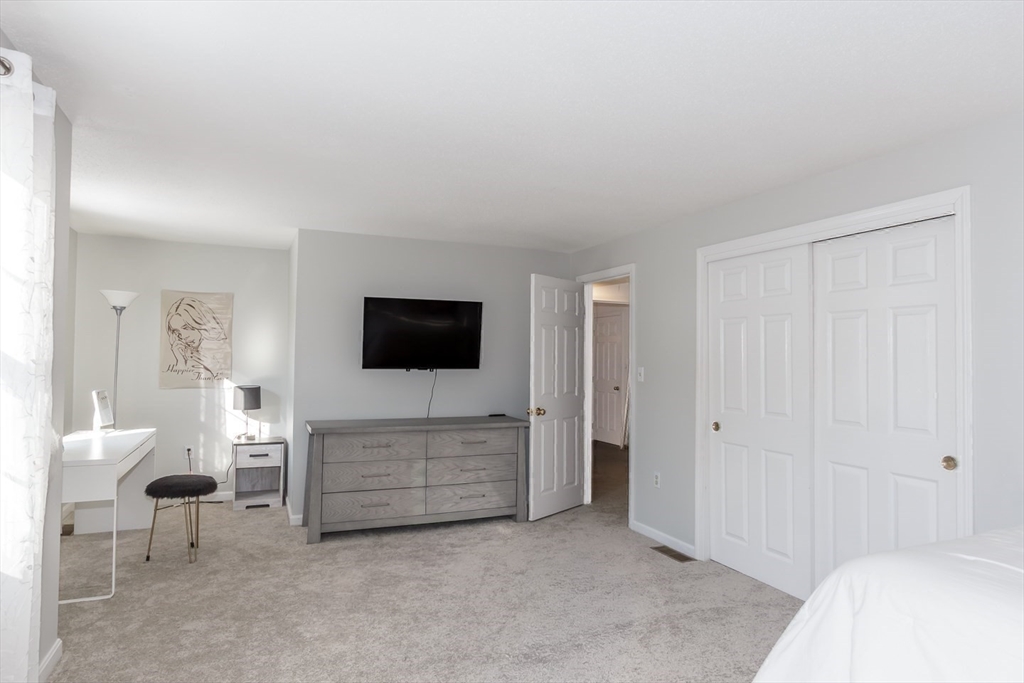 979 Hildreth Street Dracut, MA 01826 - Photo 26 of 39 a living room with furniture and a flat screen tv
