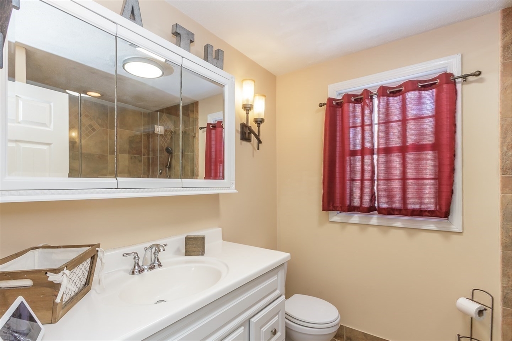 979 Hildreth Street Dracut, MA 01826 - Photo 28 of 39 a bathroom with a sink a toilet and mirror