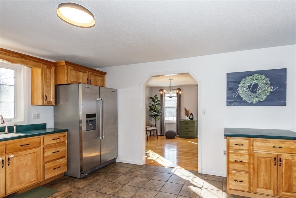 979 Hildreth Street Dracut, MA 01826 - Photo 8 of 39 a kitchen with stainless steel appliances granite countertop a refrigerator and a stove top oven