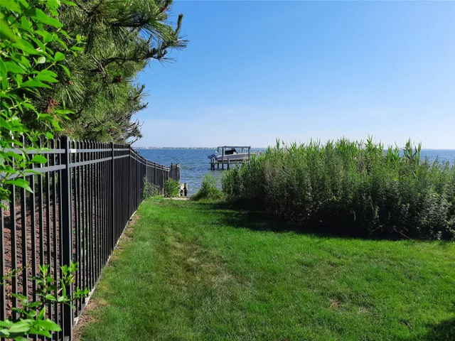 a view of a backyard with potted plants and wooden fence