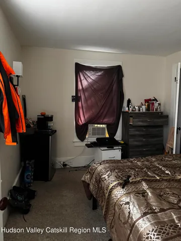 a bed sitting in a bedroom next to a window