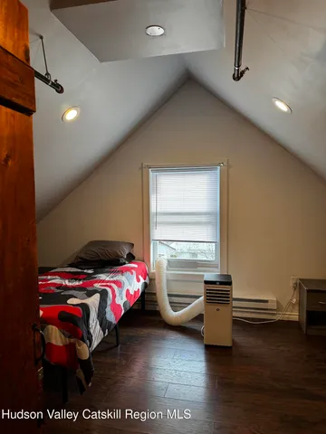 a bedroom with furniture and a wooden floor