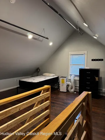 a living room with furniture a fireplace and wooden floor
