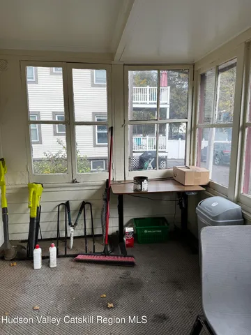a dining room with furniture and a floor to ceiling window