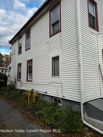 a side view of a house with a yard