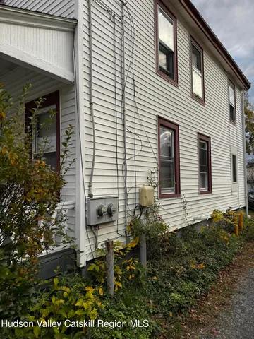 a backyard of a house with table and chairs