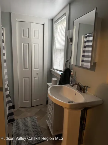 a bathroom with a sink a toilet and mirror