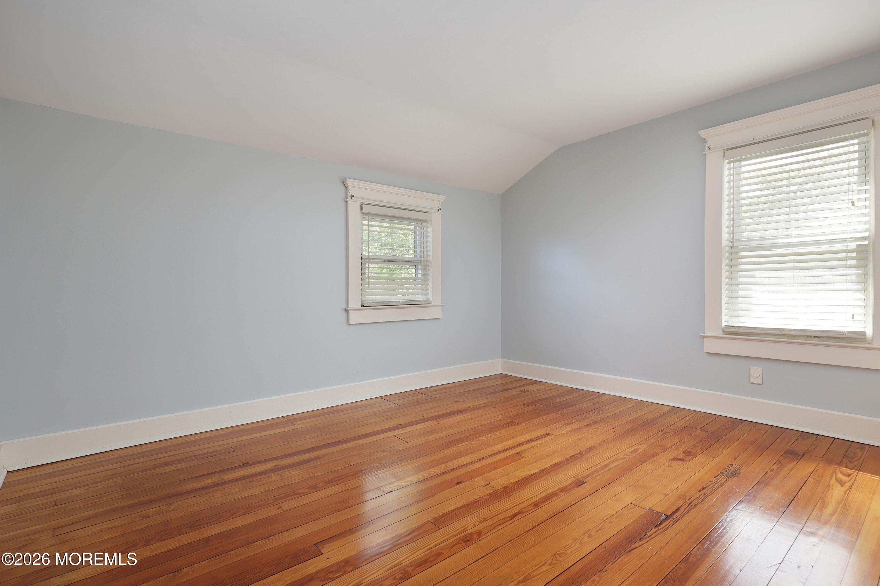 715 Howe Street Point Pleasant, NJ 08742 - Photo 20 of 45 a view of an empty room with wooden floor and a window