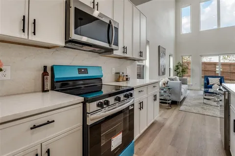 a kitchen with stainless steel appliances a stove microwave and cabinets