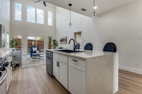 a kitchen with sink cabinets and wooden floor