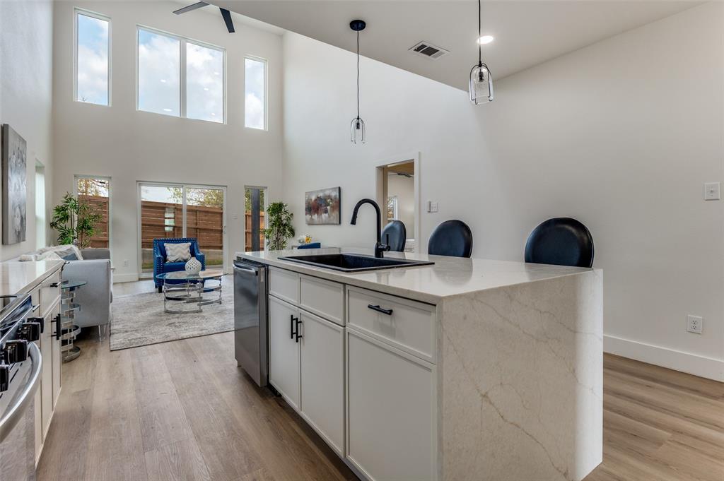 1409 Doyle Avenue Dallas, TX 75203 - Photo 16 of 40 a kitchen with sink cabinets and wooden floor