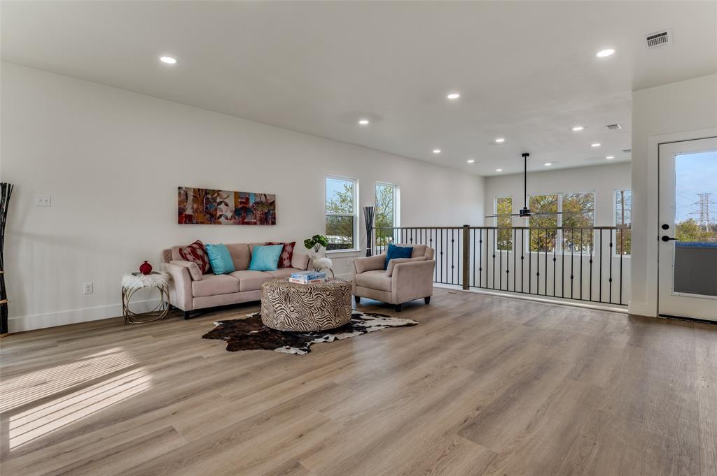 1409 Doyle Avenue Dallas, TX 75203 - Photo 18 of 40 a living room with furniture and a wooden floor