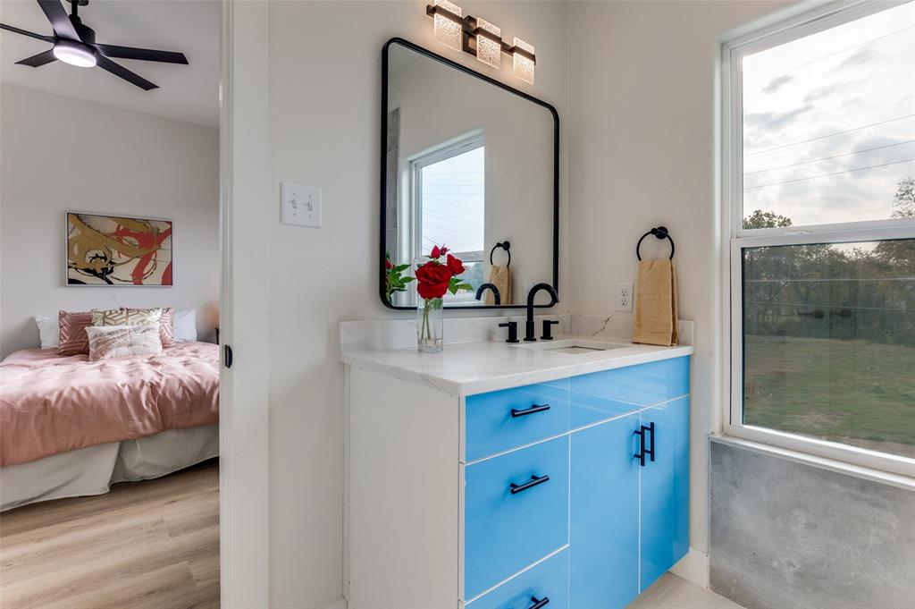 1409 Doyle Avenue Dallas, TX 75203 - Photo 21 of 40 a en suite bathroom with a double vanity sink and a mirror