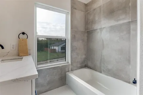 a bathroom with a bathtub and window