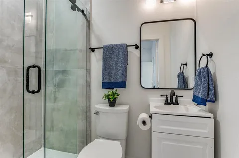 a bathroom with a toilet sink and shower