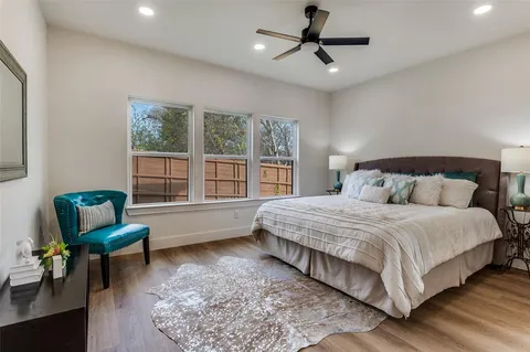 a bedroom with a bed a couch and a window